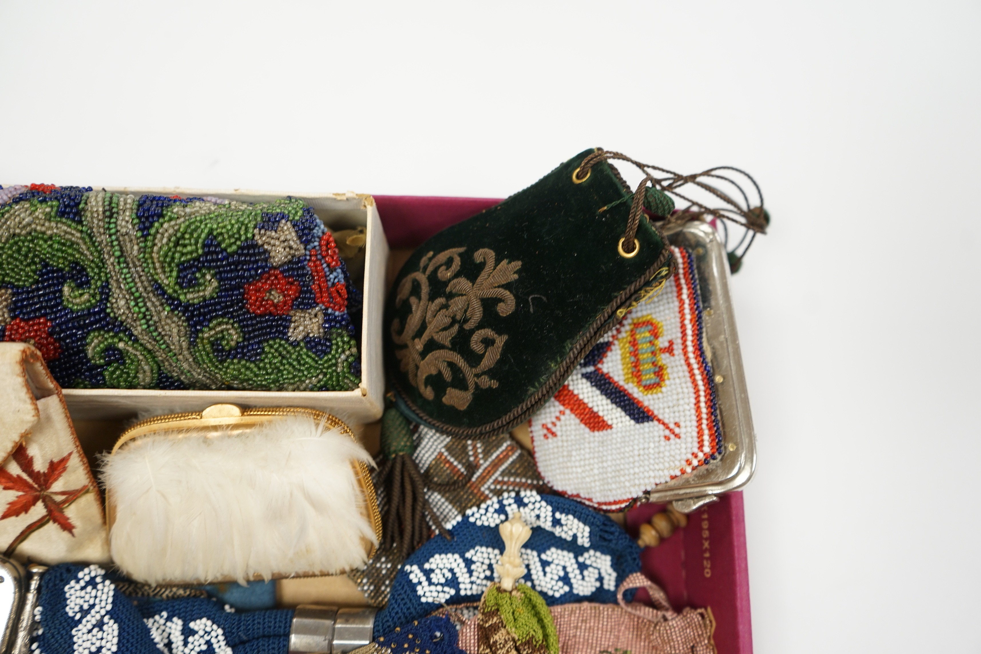 A velvet and metal embroidered reticule possibly 18th century, together with a collection of beaded embroidered knitted and leather purses, bags misers purses and a feather coin purse(14)